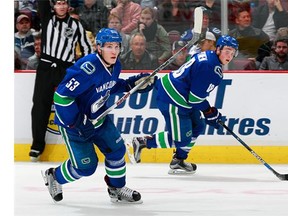 Vancouver Canucks forward Jake Virtanen, right, will be part of a Canucks’ plan to play, teach and train young players here rather than at the AHL level.