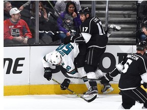 Milan Lucic of the Los Angeles Kings checks Chris Tierney of the San Jose Sharks at STAPLES Center in Los Angeles, California.