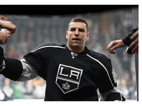 Milan Lucic #17 of the Los Angeles Kings gets high-fives from fans as he exits the ice