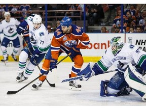Zack Kassian #44 of the Edmonton Oilers can't get a shot past goaltender Jacob Markstrom #25 of the Vancouver Canucks on April 6, 2016 at Rexall Place in Edmonton, Alberta, Canada.