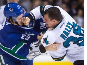 San Jose Sharks' Michael Haley, right, lands a punch to the face of Vancouver Canucks' Andrey Pedan as they fight during the first period of an NHL hockey game in Vancouver, B.C., on Tuesday March 29, 2016.