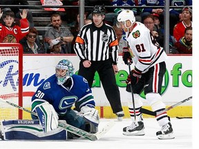 Marian Hossa #81 of the Chicago Blackhawks watches as a shot by Andrew Ladd #16 beats Ryan Miller #30 of the Vancouver Canucks for a goal during their NHL game at Rogers Arena March 27, 2016 in Vancouver, British Columbia, Canada. Chicago won 3-2.