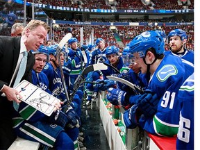 Assistant coach Glen Gulutzan of the Vancouver Canucks discusses strategy with seconds remaining against the New York Islanders during their NHL game at Rogers Arena March 1, 2016 in Vancouver, British Columbia, Canada.