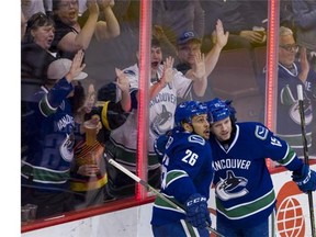 Vancouver Canucks #26 Emerson Etem and #15 Derek Dorsett celebrate Etem's goal on the Edmonton Oilers during the third period of the final regular season NHL hockey game at Rogers Arena, Vancouver April 09 2016.