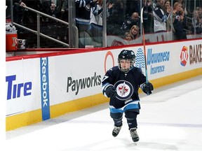 Honorary first star Connolly Gamble of the Winnipeg Jets takes a lap around the ice following NHL action between the Jets and the Anaheim Ducks at the MTS Centre on March 20, 2016 in Winnipeg, Manitoba, Canada.
