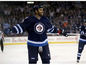 Dustin Byfuglien laughs after scoring from just inside centre ice against the Coyotes.
