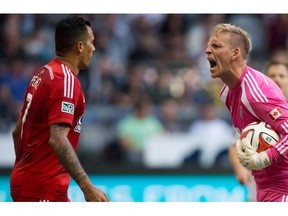 Whitecaps goalkeeper David Ousted yells at ex-Dallas striker Blas Perez after some gamesmanship in the box. The two are now teammates.