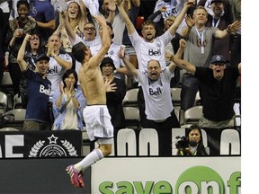 Whitecaps FC Octavio Rivero leaps in front of jubilant fans after scoring the first goal against the Colorado Rapids in B.C. Place Stadium in Vancouver on September 9, 2015.