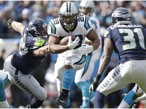 Carolina Panthers running back Jonathan Stewart (28) runs against Seattle Seahawks strong safety Kam Chancellor (31) during the first half of an NFL divisional playoff football game, Sunday, Jan. 17, 2016, in Charlotte, N.C.