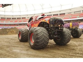 Two of the starring 10,000-pound trucks rest at B.C. Place before Saturday’s Monster Jam show.