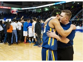 Steveston-London’s head coach Mike Stoneburgh consoles Nigel Boyd after losing to Southridge during the 2016 Boys triple-A High School Basketball Championships at the Langley Event Centre on Saturday.