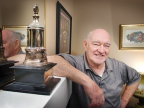 Charlie Hodge at home in 2007, posing with a miniature of the Vezina Trophy, which he won in 1965.  (Ian Lindsay/PNG)