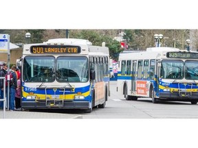 Transit users cue to board a Coast Mountain bus at the Surrey Central Exchange, one station in the Translink infrastructure in Surrey, B.C. Thursday March 12, 2015.