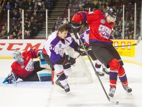 Team Cherry’s Markus Niemelainen, right, is knocked by Team Orr’s Jack Kopacka during the Top Prospects Game on Thursday at the Pacific Coliseum.