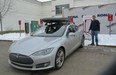 David Webster tops up his Tesla S85 at a new charging station in Kelowna. —
