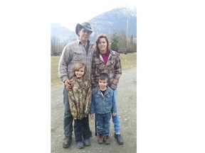 Timothy Michalchuk, Shannon Dickson and their kids Mavorneen and Peter pose for a family portrait at their home in Bella Coola.