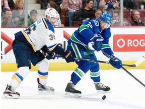 Troy Brouwer of the St. Louis Blues pursues Vancouver Canucks forward Chris Higgins Saturday at Rogers Arena. St. Louis won 3-0.