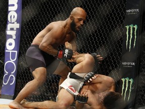 Demetrious Johnson, left, fights Henry Cejudo during a flyweight championship mixed martial arts bout at UFC 197, Saturday, April 23, 2016, in Las Vegas. (AP Photo/John Locher) ORG XMIT: NVJL126