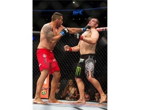 United States' Cain Velasquez, right, battles against Brazil's Fabricio Werdum during a men's heavyweight title mixed martial arts bout at UFC 188 in Mexico City, Saturday, June  13, 2015. Werdum won the fight by submission. (AP Photo/Christian Palma)