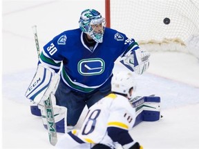 Vancouver Canucks' goalie Ryan Miller allows what proved to be the winning goal to Nashville Predators' James Neal, bottom, during third period NHL hockey action, in Vancouver on Tuesday, Jan. 26, 2016. Jason Botchford believes trading Miller should be one of the Canucks' options.