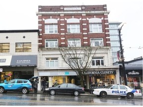 Vancouver police were on the scene Sunday at the Edwards Block apartment block, right, at 2425 Granville, near West Broadway.  Kim Stallknecht/PNG