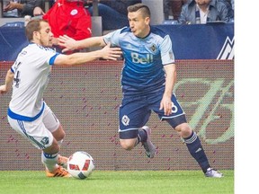 Vancouver Whitecaps right-back Fraser Aird, right, battles for the ball with the Montreal Impact’s Harry Shipp on Sunday at B.C. Place Stadium. Defensive mistakes led to a 3-2 Caps loss. Ric Ernst/PNG