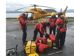 North Shore Rescue were brought in  Jan. 29, 2016 to rescue a missing snowboarder on Cypress Mountain. Pictured here are rescuers staging for the search above the Howe Sound, flight team is staging out of Sunset Marina, north of Horseshoe Bay. The snowboarder, a 40-year-old Surrey man, was found dead on Saturday morning.