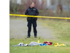 New Westminster Police on the scene of an officer-involved shooting behind the Walmart in the Queensborough Landing on Friday, Jan. 15, 2016. A medical kit sits on the dike behind the mall.