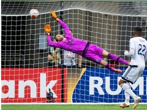 Whitecaps goalkeeper Paolo Tornaghi dives for a shot that soars over the net during CONCACAF Champions League against Seattle last August, but he hasn’t played an MLS game for Vancouver.