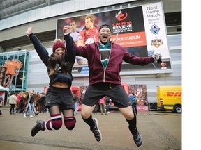 Wild and colourful rugby fans show off their best outside B.C. Place Stadium during the sevens tournament in Vancouver on Sunday. Here, New Zealand fans Chynna Koonpack Dee and Johnny Hgo celebrate in front of the stadium.