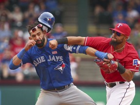 Toronto Blue Jays Jose Bautista (19) is punched by Texas Rangers second baseman Rougned Odor (12) after Bautista slid into second in the eighth inning of a baseball game at Globe Life Park in Arlington, Texas, Sunday May 15, 2016. Reports indicate Rangers infielder Odor will sit eight games for delivering a punch to the jaw of Blue Jays slugger Jose Bautista in a game last Sunday. THE CANADIAN PRESS/ AP-Richard W. Rodriguez/Star-Telegram via AP ORG XMIT: CPT116
