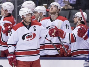 Carolina Hurricanes Eric Staal is congratulated by teammates after scoring on the Toronto Maple Leafs during second period NHL action in Toronto on Monday, January 19, 2015. THE CANADIAN PRESS/Frank Gunn