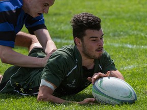 Robert Bateman Timberwolves outside centre Jared Embree (right) crosses the try line to score for his Abbotsford-based school Wednesday in a 22-17 double-A Tier 2 victory over Richmond’s R.A. McMath Wildcats in the opening round of the B.C. high school rugby championships. Action runs through Saturday in Abbotsford. (Photo — Rick MacDonald, BCSSRU)