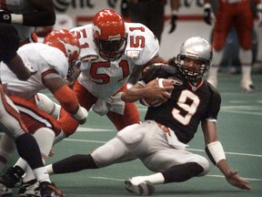 Alondra Johnson (51) in action for the Stampeders vs. Damon Allen and the LIons. Johnson's son has signed on with the Lions ahead of training camp. (Jon Murray/Province)