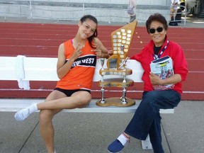 Nina Schultz and her grandma, Zheng Fengrong, celebrate Schultz's second straight Top Female Athlete award at last spring's BC high school championships. (Schultz family)