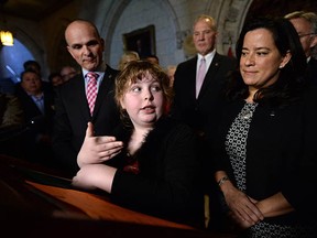 Transgender activist Charlie Lowthian-Rickert speaks alongside Justice Minister Jody Wilson-Raybould, right, during Tuesday's announcement in the foyer of the House of Commons in Ottawa. The legislation extends protection to those facing discrimination on the basis of their gender identity or expression.