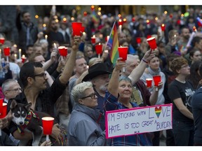 Vancouver  B.C.  June 12, 2016  in Many gathered for a vigil outside the Vancouver art gallery to pay tribute to people killed in an Orlando,  Florida. night club on June 12, 2016. At least 50 people were killed and more than 50 others were wounded when a gunman opened fire and took hostages at a gay nightclub in Orlando, Florida, early Sunday morning.    Mark van Manen/ PNG Staff photographer   see Main for* Cheryl Chan Province Vancouver Sun News    Features  stories  Web. stories.   00043677A [PNG Merlin Archive]