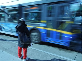 A transit user watches the TransLink bus whiz by.