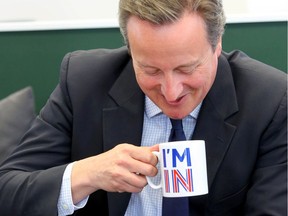 Britain's Prime Minister David Cameron sips from an "I'm In" mug as he meets television presenters Jeremy Clarkson and James May during a visit to W Chump & Sons Ltd TV studio in west London on June 16, 2016 ahead of the EU referendum as the prime minister campaigns to avoid a Brexit.  Britain goes to the polls on June 23 to vote to remain or leave the European Union in a referendum. / AFP PHOTO / POOL / Gareth FullerGARETH FULLER/AFP/Getty Images