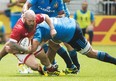 Canada&#039;s Ray Barkwill, left, gets tackled by Italy&#039;s Marco Fuser, right, during first half summer series rugby action in Toronto on Sunday, June 26, 2016. THE CANADIAN PRESS/Nathan Denette