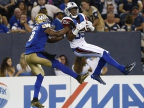 Montreal Alouettes' Duron Carter (89) can't hang onto the ball as Winnipeg Blue Bombers' Chris Randle (8) defends during the first half of CFL action in Winnipeg Friday, June 24, 2016. THE CANADIAN PRESS/John Woods ORG XMIT: JGW112