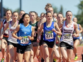Desirae Ridenour (right, 242) of Duncan’s Cowichan Thunderbirds, takes the inside track on Christina Sevsek (middle) of Surrey’s Clayton Heights and Jouen Chang of Langley’s Credo Christian, en route to an eventual 10-second win in the senior girls 3,000 metres at the 2016 B.C. high school track and field championships in Nanaimo on Saturday.