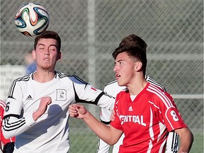 Dr Charles Best's senior forward Chris Bastow (left) wins aerial battle with Burnaby Central's Brady Hughes during semifinal action from 2015 B.C. Triple A boys soccer championships played Friday at Burnaby Lakes.