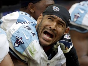 Tennessee Titans linebacker Derrick Morgan reacts to receiver DeAndre Hopkins' scoreboard stats in a 2014 game. He is equally dismayed with the NFL's stance on medical marijuana.