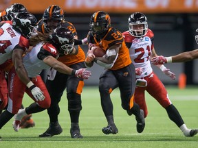 B.C. Lions running back Jeremiah Johnson carries the ball past the Calgary Stampeders defence during the fourth quarter of last Saturday's game at B.C. Place.