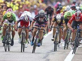 Germany's Andre Greipel, right, crosses the finish line ahead of Peter Sagan of Slovakia, left, Norway's Alexander Kristoff, second left, and Germany's John Degenkolb, center, to win the the fifteenth stage of the 2015 Tour de France.