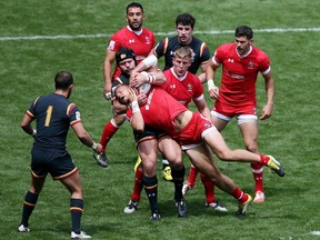 Canada's Harry Jones is tackled by Wales Adam Thomas during day two of the Sevens World Series at Twickenham Stadium in London, Sunday May 22, 2016.