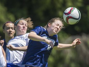 BC triple-A tournament MVP Jessica Galbraith (right) nods the ball clear of Handsworth's Jade Fraser during B.C. title tilt Saturday in Tsawwassen. (Arlen Redekop, PNG photo)