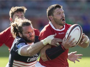 Canada's James Pritchard (right) is tackled by USA's Todd Clever during second half Rugby World Cup Qualifying action in Toronto on Saturday August 24, 2013.