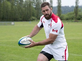 Rugby Canada team member Jamie Cudmore carries the ball at the team's practice facility in Burnaby, B.C.